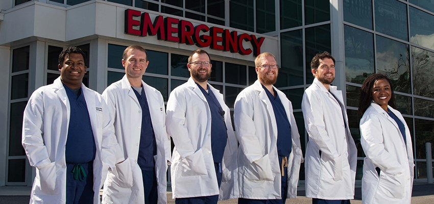 From left, Andy Nadarajan, M.D.; Alexander Angelidis, D.O.; Christopher Musselwhite, M.D.; Blake Holloway, M.D.; Kyle Beasley, M.D.; and Elizabeth Ekpo, M.D., were members of the inaugural class of emergency medicine residents.Download larger image