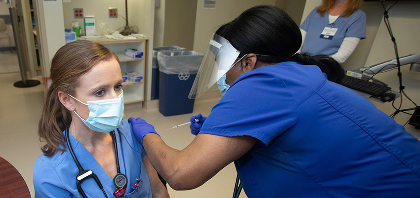 A USA Health resident receives the COVID-19 vaccine.