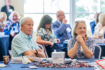 Lifetime members sitting at event in alumni center.