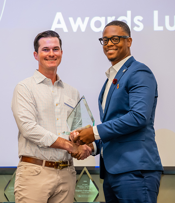 One man gives another man an award