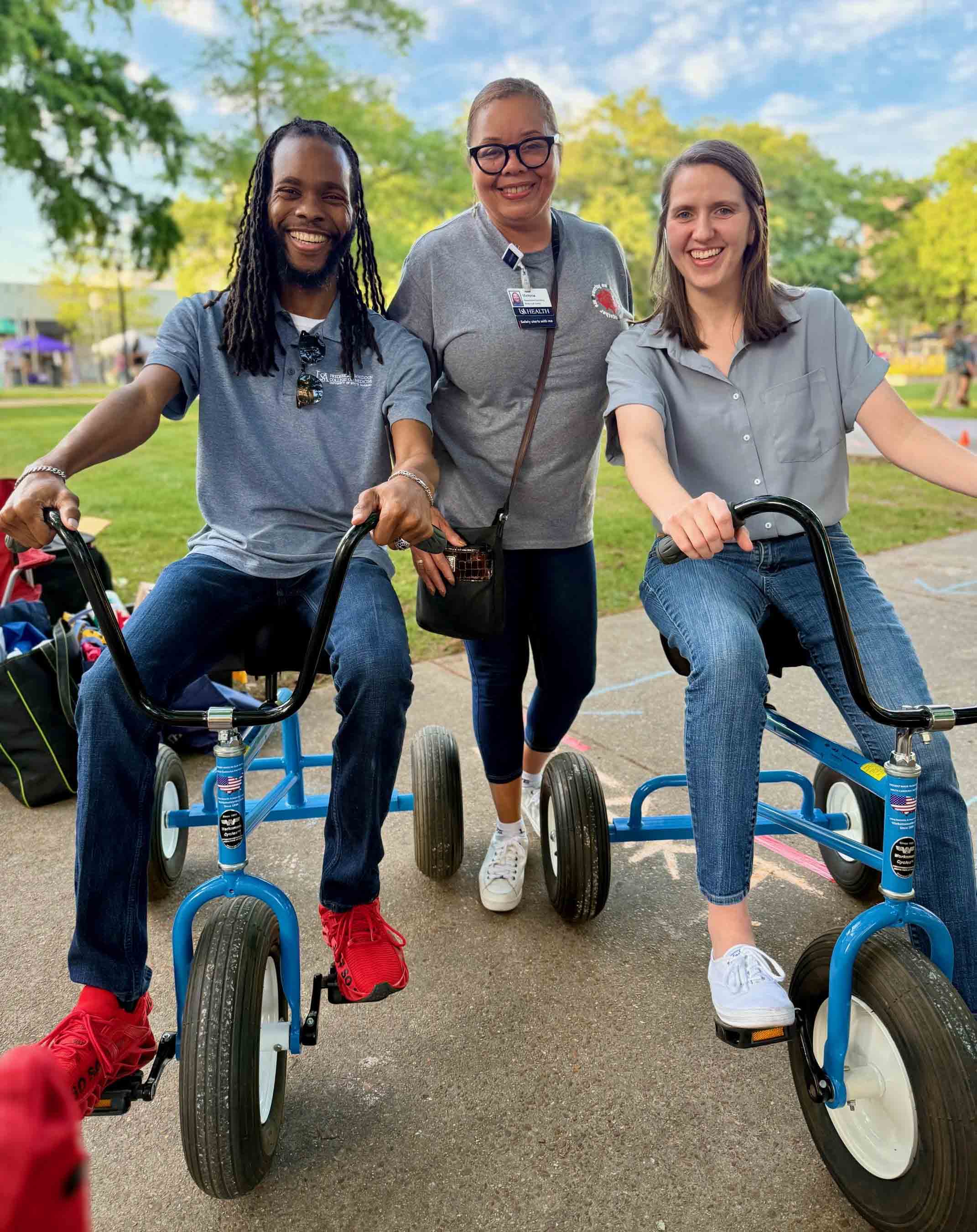 Three people on tricycles