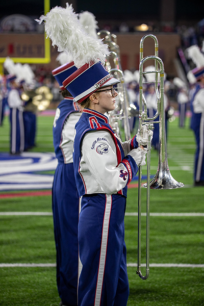 Emily Sims in Marching Band uniform performing at football game.