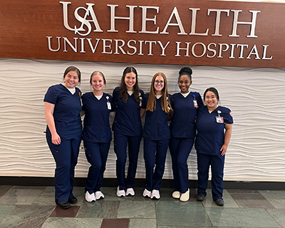 Emily Sims with fellow nursing students at USA Health University Hospital.
