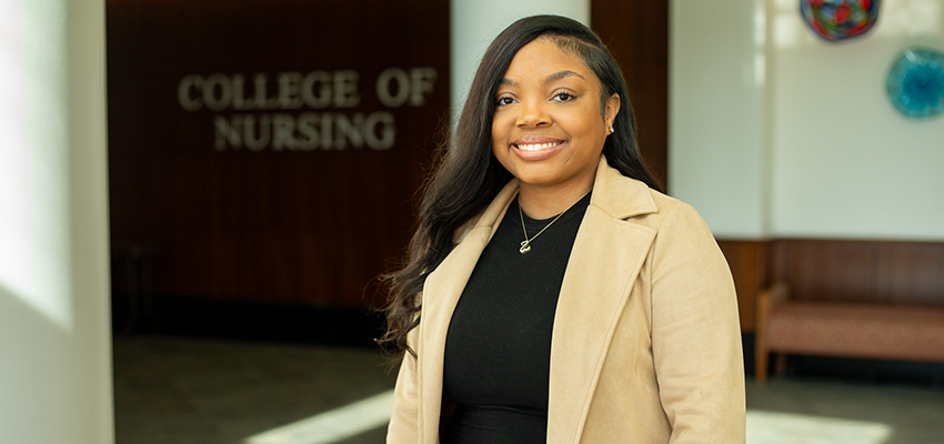 Jakeria Wilder standing in front of the College of Nursing.