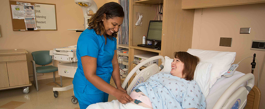Nurse working with woman in delivery