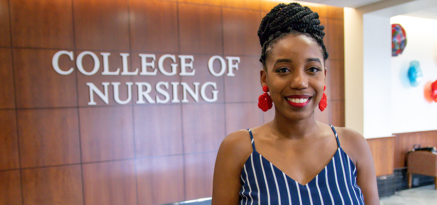 Nicole Everett in front of the College of Nursing.