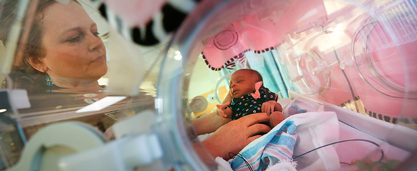 Neonatal Nurse Practitioner working with baby