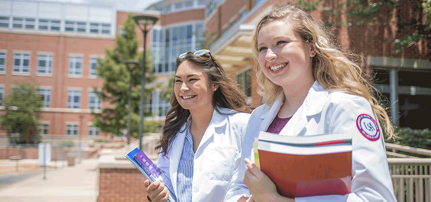 RN to BSN College of Nursing students walking outside of the building.