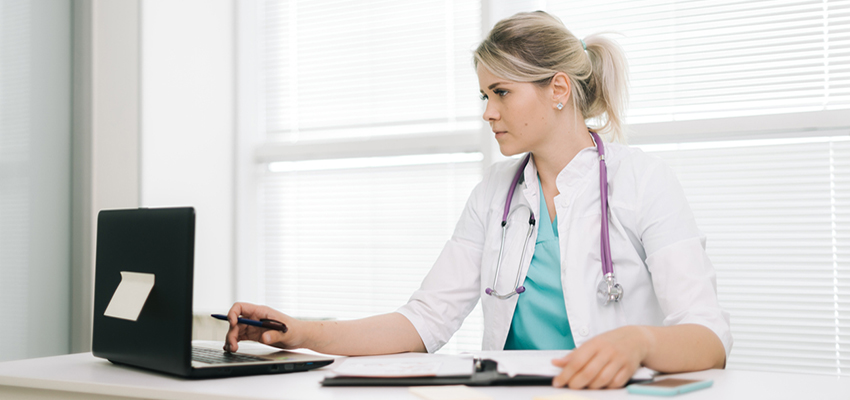 Nurse working on laptop.