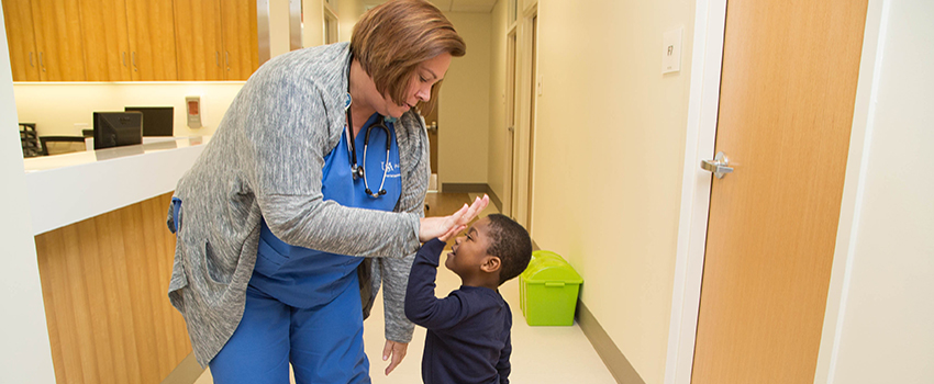 Nurse giving a high five to little boy