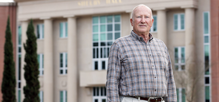 Bill Burnsed Jr. standing in front of Shelby Hal