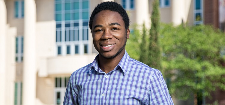 Bryant Baldwin stnading in front of Meisler Hall.