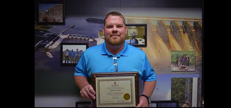 Environmental Engineer Andrew Patch poses for a photo, June 28, with a Certificate in Water Reclamation from the University of Wisconsin-Madison College of Engineering. 