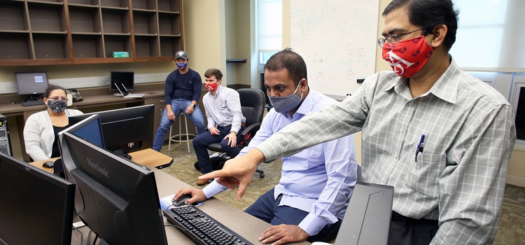 University of South Alabama students Crystal Pitts, Josh Yang, Aaron Mattox, Muhammed Mubasshir Hossain and Associate Professor Dr. Saeed Latif meet to discuss the SWARM-EX project that will lead to small satellites launched into the atmosphere. Dr. Saeed Latif and a group of engineering students at the University of South Alabama are preparing to explore space with a satellite project called SWARM-EX.

The plan is to launch three identical CubeSats - miniaturized, light-weight and low-cost satellites - to form a small constellation orbiting around the Earth. The satellites will feature new technologies for advanced data downlinks, radio communication among satellites, and onboard propulsion for autonomous operations within the swarm.