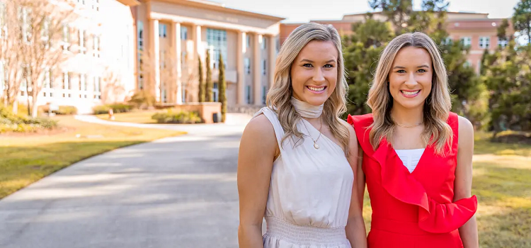 Logan, left, and Mallorie Collins, twin sisters from Satsuma, Alabama, share a residence hall suite, a major in mechanical engineering and a spirit for cheering on the Jaguars. data-lightbox='featured'