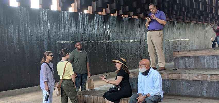 Students and faculty talking inside of Legacy Museum.