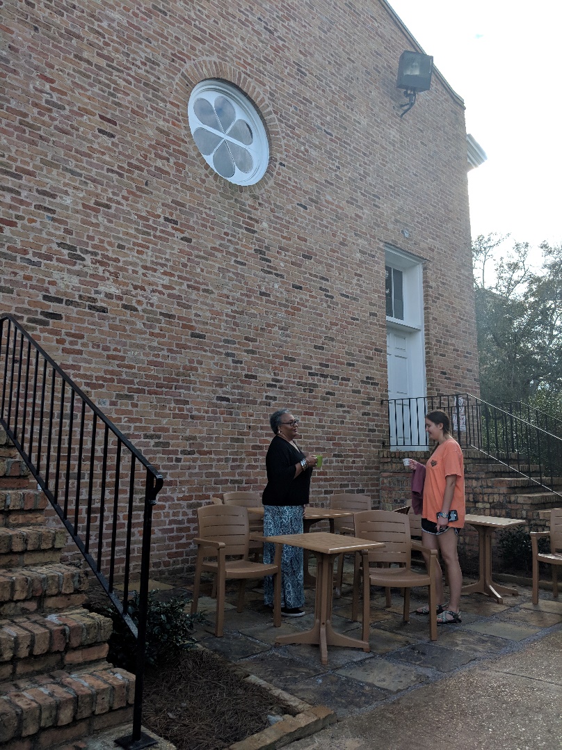 Woman and female student enjoying coffee outside