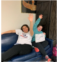 Matysan and Emily raise their hands during a group discussion.