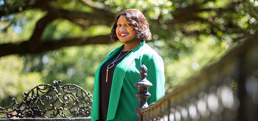 Raven McShan standing outside honors college