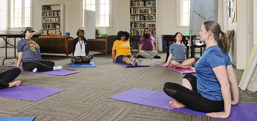 Sara Schrenk leads a yoga class at the Bethel for Honors College