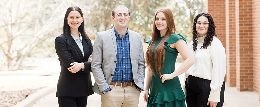 MCOB students standing outside on campus.