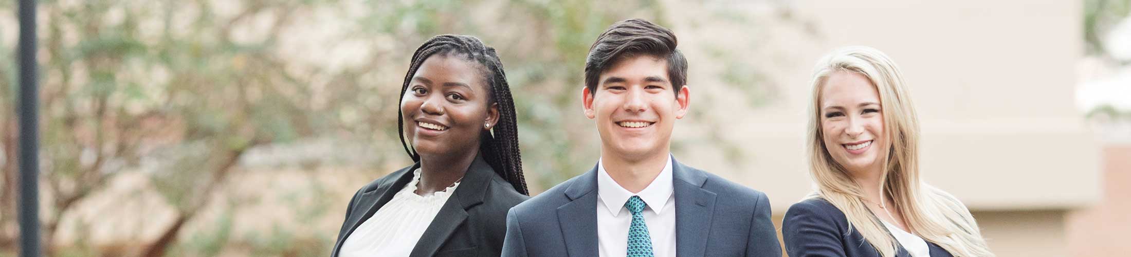 Mitchell Ambassadors standing outside.