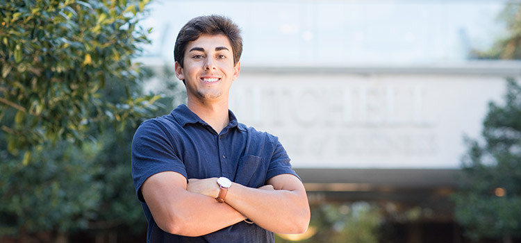 Santiago Montiel standing outside the Mitchell College of Business data-lightbox='featured'