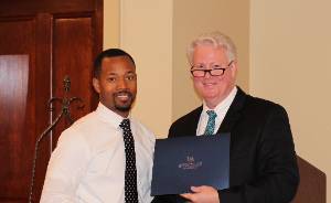 A professor presenting an award to a student.