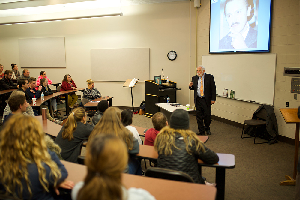 Aaron Beam presenting to a group of students