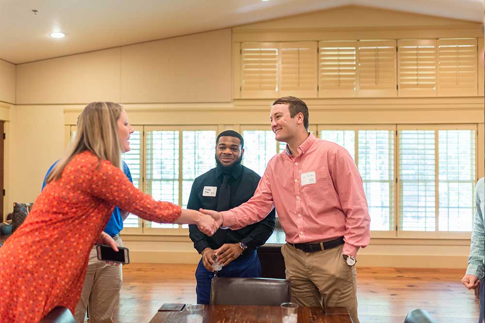 Students network with bank representatives.
