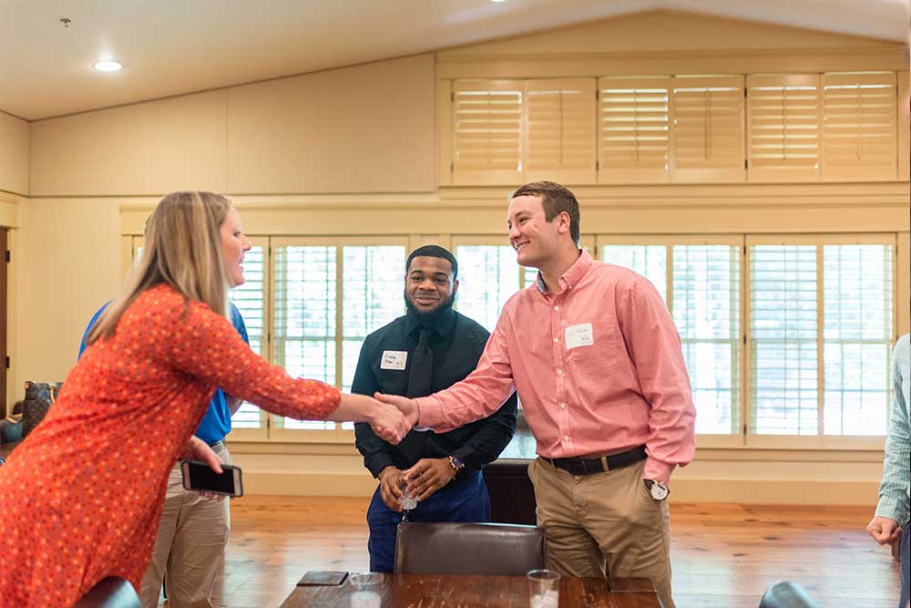 Students network with bank representatives. 