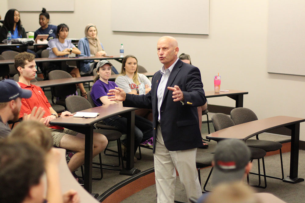 Admiral Dean Lee speaking to seniors