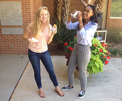 Two students eating hot dogs