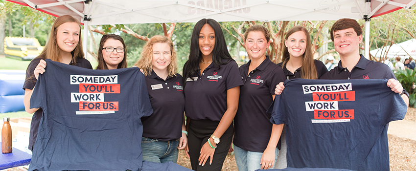 Students holding up MCOB shirts during Get Connected Day