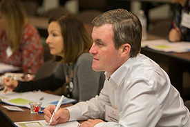 Students taking notes at Women in Business