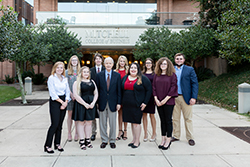 Mr. Mitchell standing with scholars in front of MCOB