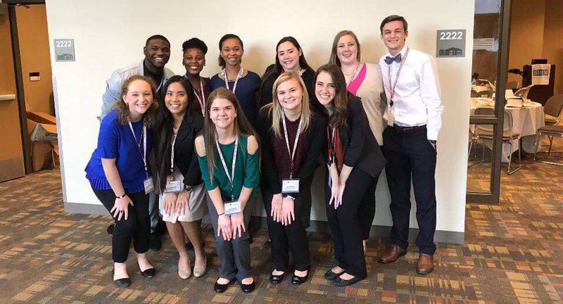 MCOB Student Group smiling after receiving award.