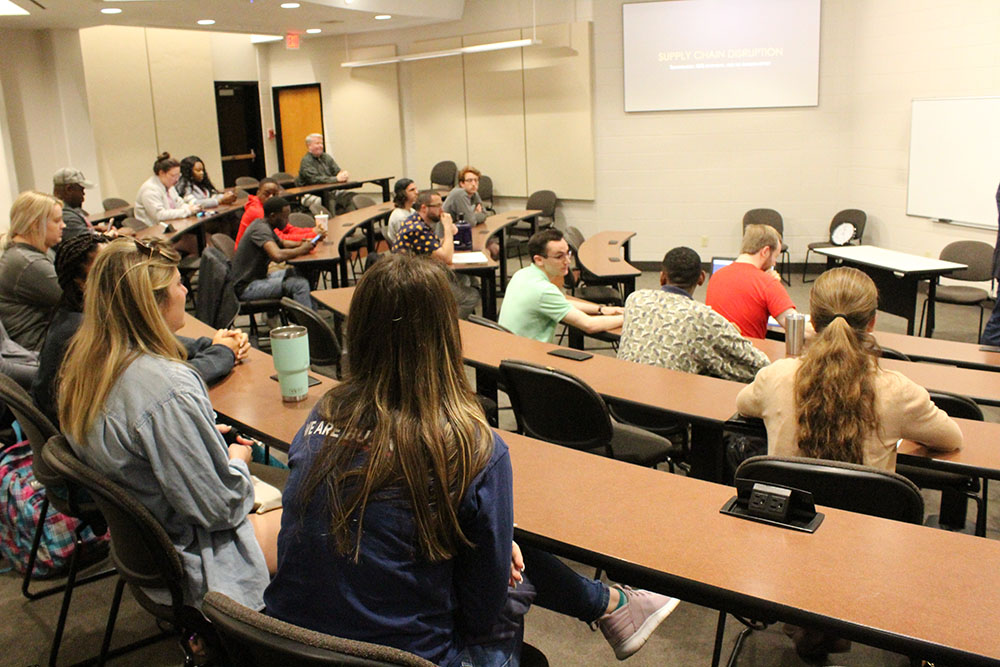 Students attending event with speaker from Amazon.