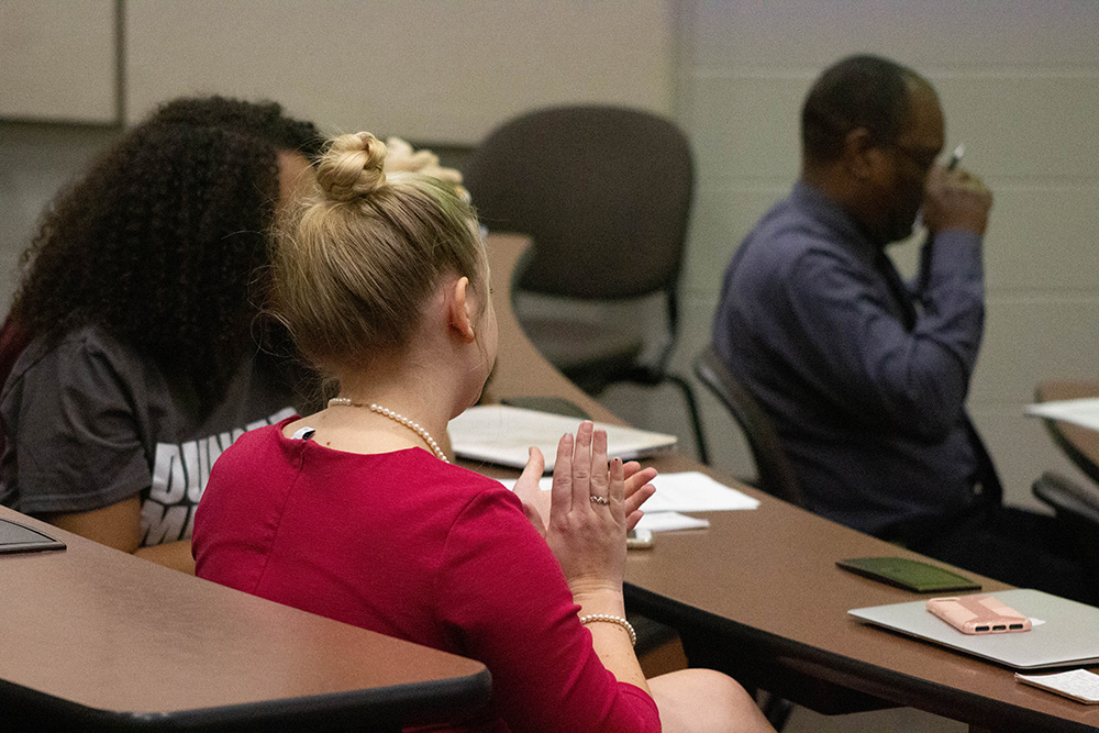 Students applauding other student presentations.