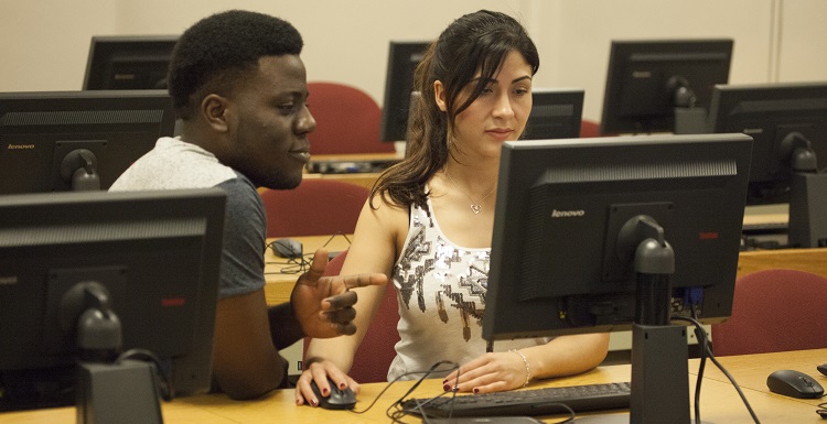 Adesina Tony Dada, left, a junior majoring in mechanical engineering, works with Ximena Horness, a graduate student in accounting, to prepare his tax return as part of a program available to South students, faculty and staff. data-lightbox='featured'