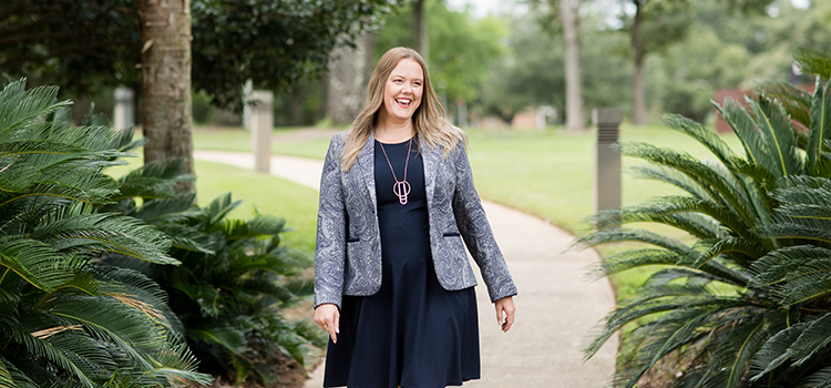 Dr. Robyn L. Brouer walking on path outside of MCOB.