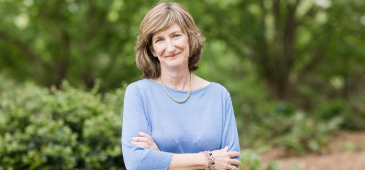 Dr. Kelly Collins Woodford standing outside on campus.