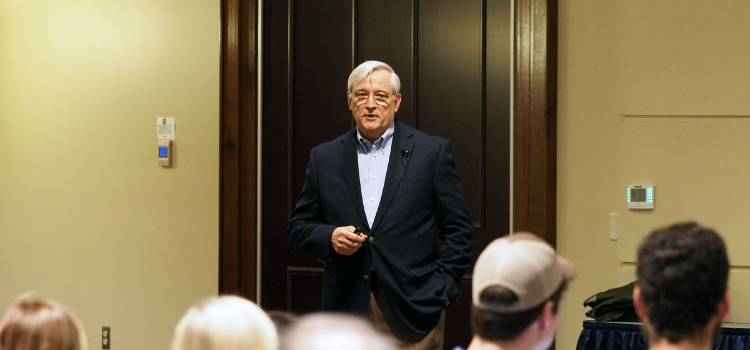 Chris Melton speaking in front of a group.