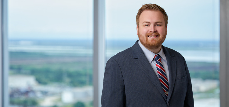 Josh Crownover standing in front of office window.