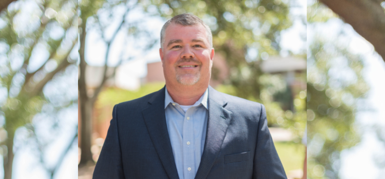 Dr. Chris Lawrey, standing outside on campus.