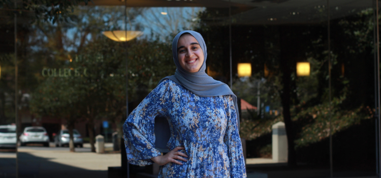 Mariam El-Sharkh standing outside of Mitchell College of Business.