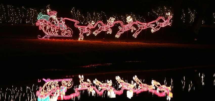 Bellingrath in Lights -- santa's sleigh reflects on the pond
