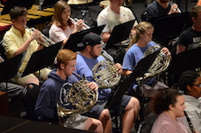 Pictured performing on stage is a portion of the USA Symphony Band.