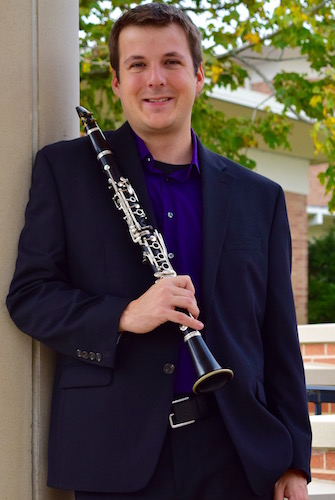 Dr. Kip Franklin standing outside with clarinet in hand