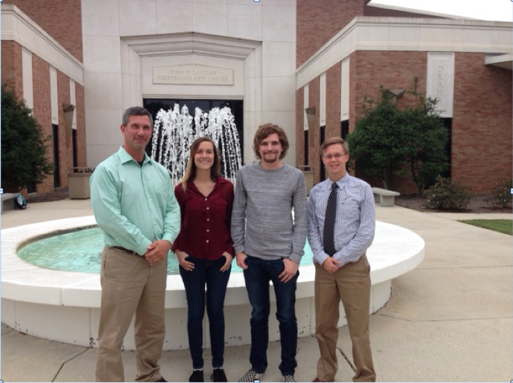 Dr. Michael Phillips (Advisor), Alyssa Weiskopf, William Jake Cannon, and Steven Reed Gilmore standing in front of fountain outside Laidlaw